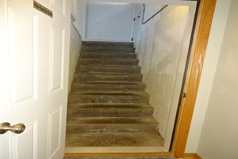 Stairs to garage as secondary exit to back yard.
