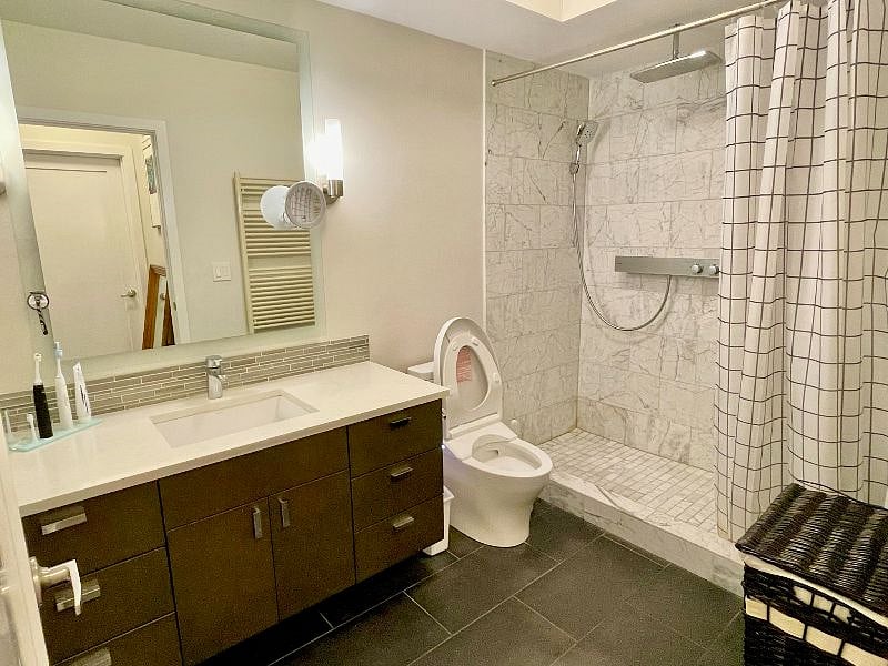 Fully tiled walk-in shower and towel warmer