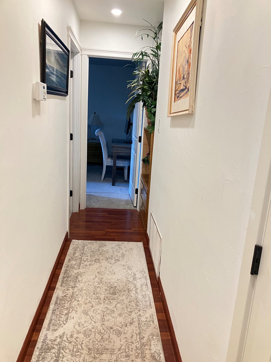Hallway to master bedroom straight ahead and spare bedroom on the left.