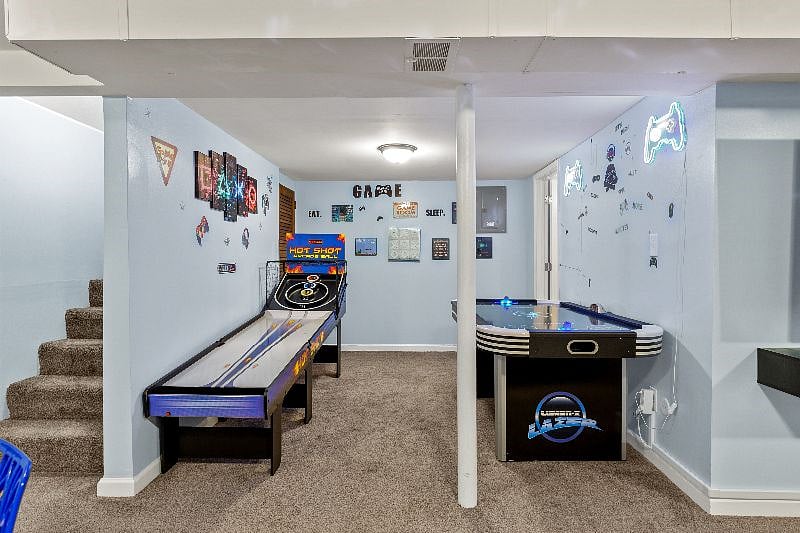1st gaming section with air hockey and skeeball table.
