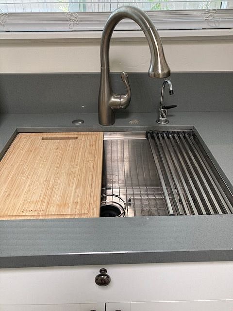 Stainless Sink w/rack, strainer and cutting board.  Garbage disposal
