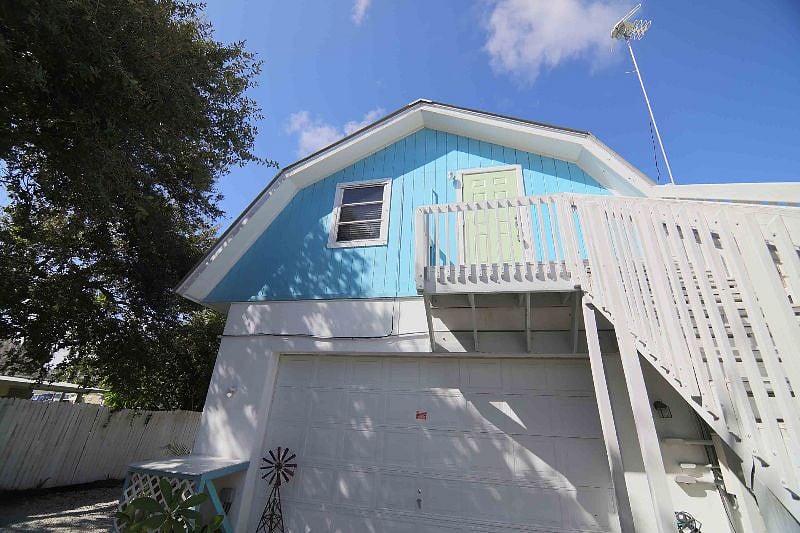Private 2nd story entrance on back side of multi-family home. Private parking. 