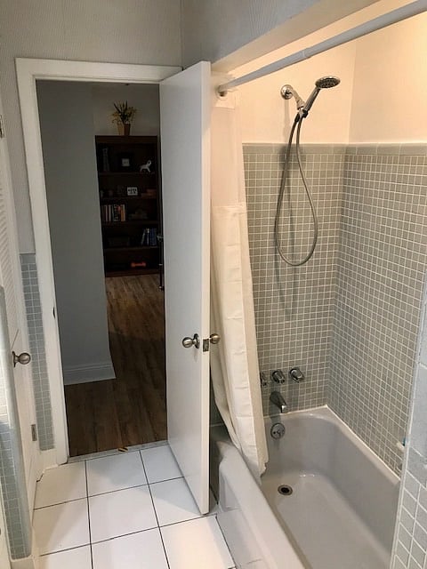 60s themed original second bathroom with a tub/shower 