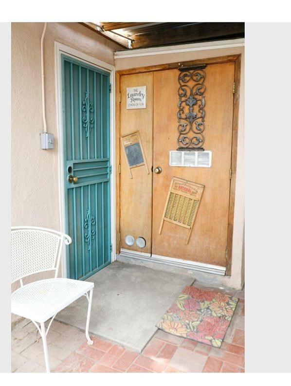 Security Gate to front door. Stackable washer/dryer located behind wood door.