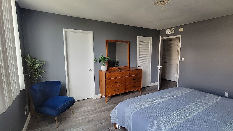 Primary bedroom. Ensuite bathroom is the solid door on the left, walk in closet is the door to the right of the dresser.
