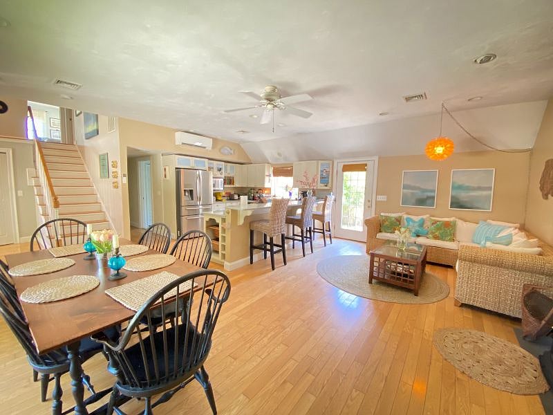 View of Kitchen from Corner of the Living Room, showing stairs to 2nd floor Den