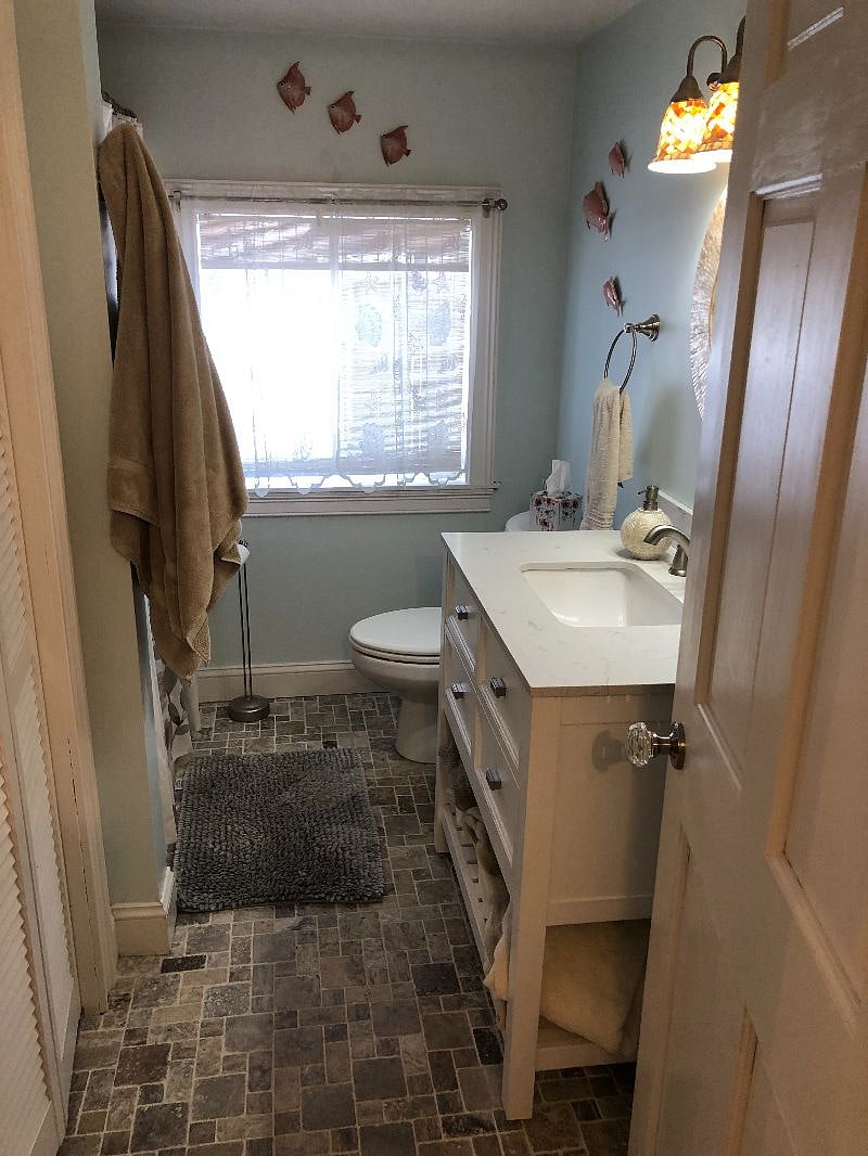 Main Bathroom in the 1st floor hallway. There is a washer and dryer in the closet on the left.