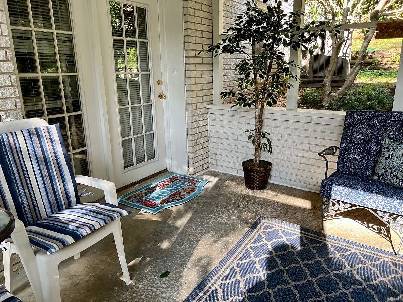 Inside the screened in porch and the entrance to the apartment. 