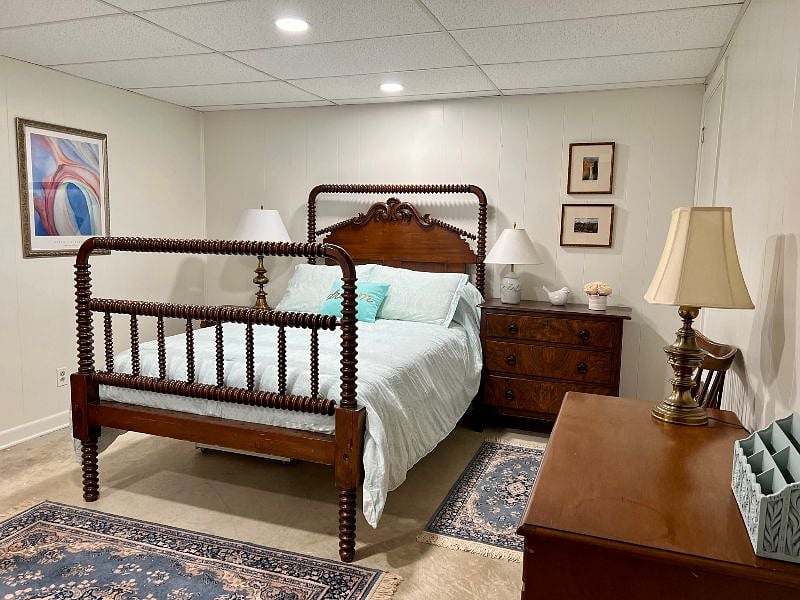 Bedroom includes a desk, two nice sized dressers and a bedside table.