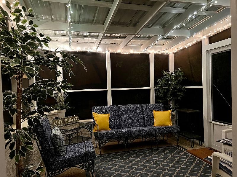Twinkle lights on the porch for cozy nights.