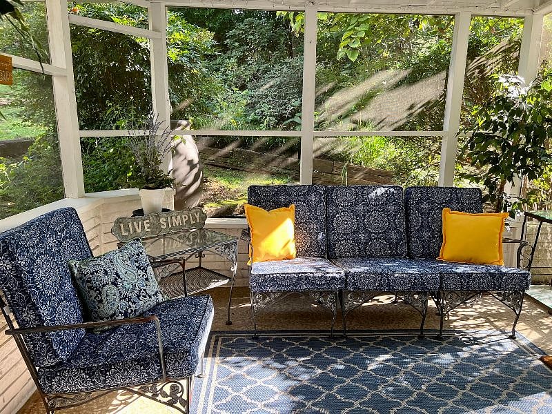 Plenty of cozy seating on the porch, as well as a small table and two chairs for dining.