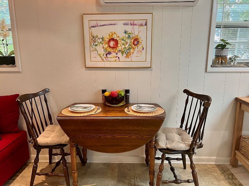 Dining table when open full size is oval shaped and can comfortably seat 4 people, six if needed.