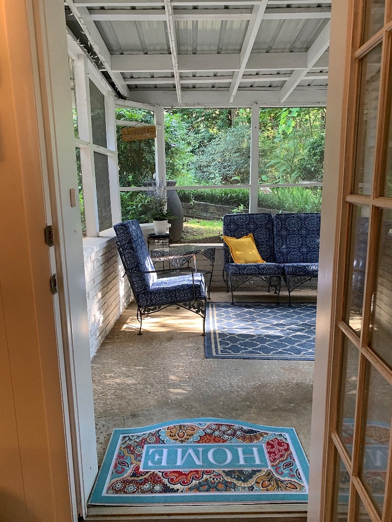 View looking from inside the apartment out onto the screened in porch.