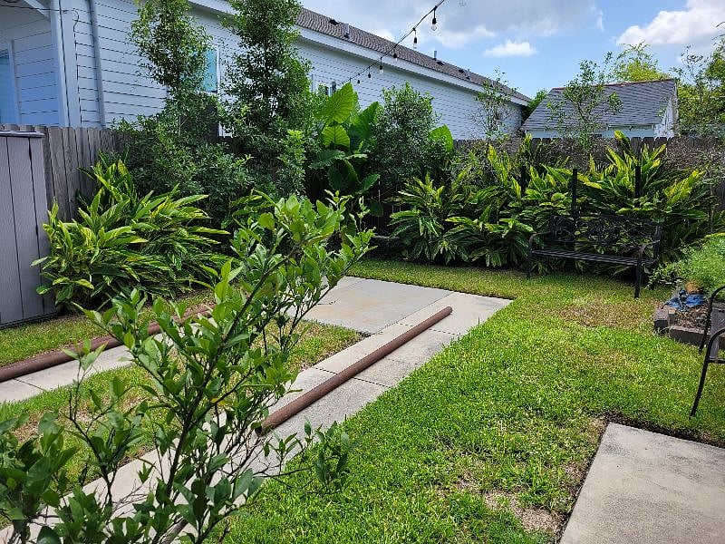Yard area with parking, bbq pit, string lights