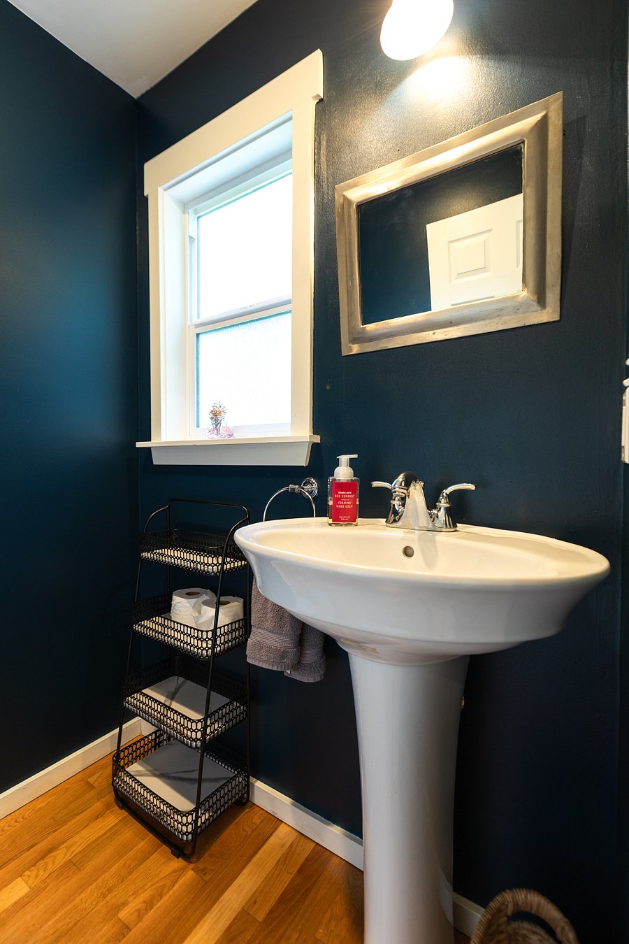 Dark blue 1/2 bath on the main floor.