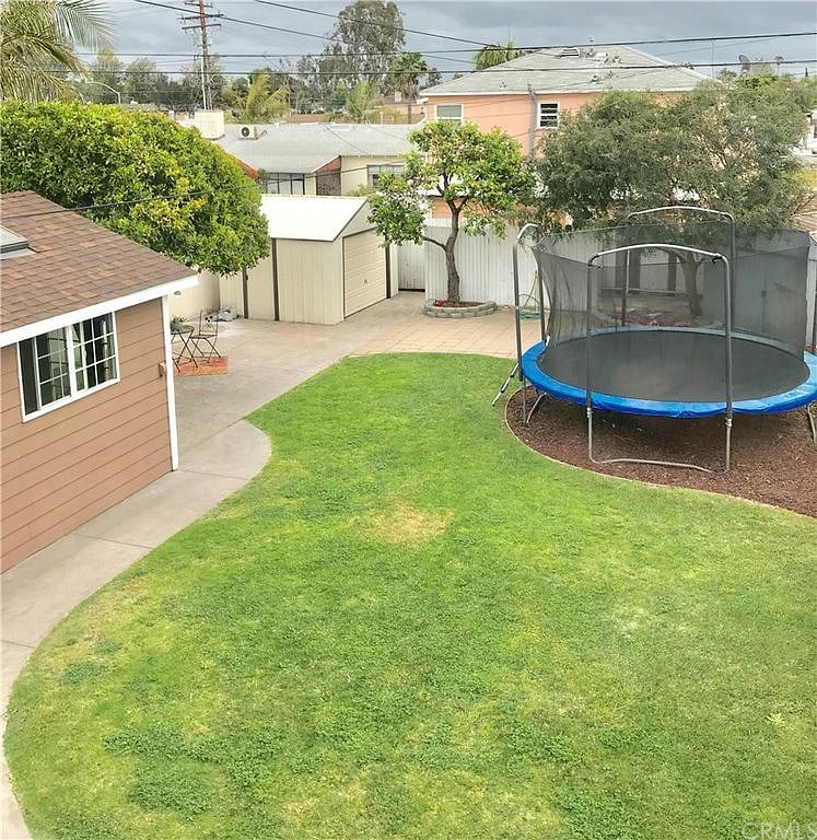 Common area backyard has a trampoline and hot tub for your enjoyment! This view of the guest house and yard are from the 2nd floor of the front house.
