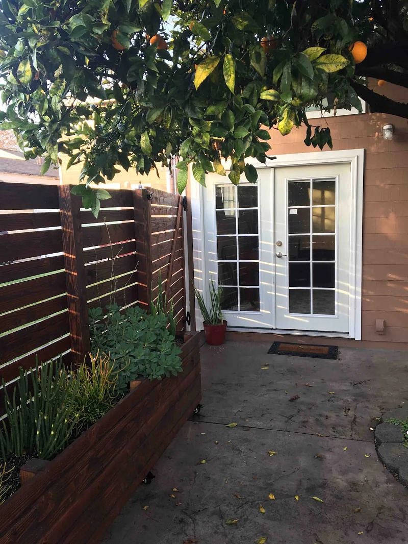 Here's your private entrance in the Guest House's enclosed patio beneath the lush orange tree.