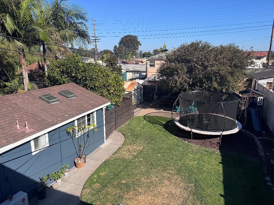 Common area backyard has a trampoline and hot tub for your enjoyment! This view of the guest house and yard are from the 2nd floor of the front house.