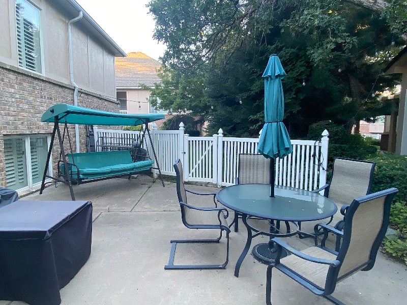 Shared patio space with couches, tables, fire table, and BBQ grill