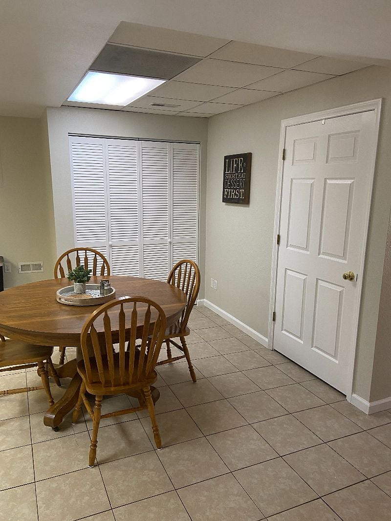 Washer and Dryer behind louvered doors. Other door is a pantry with shelves.