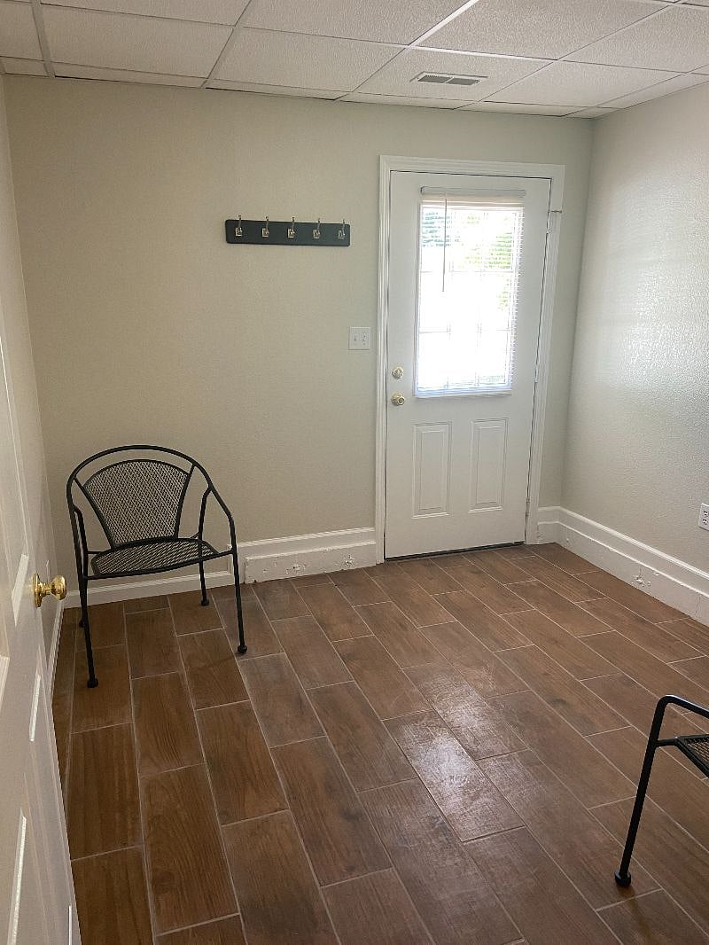 This room is the second entrance and now has a desk and chair for office space.
