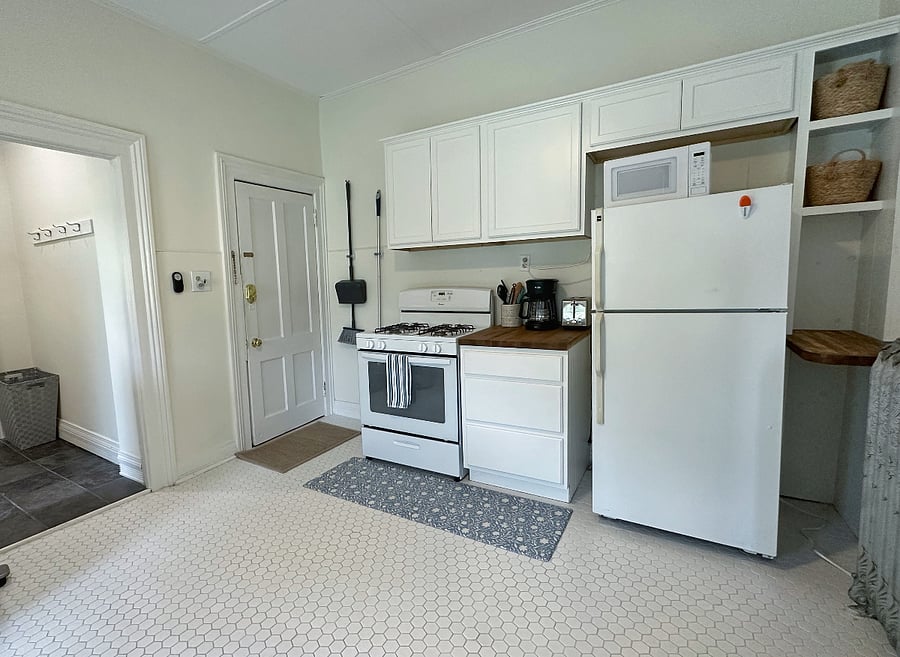 Full fridge, stove/oven, and includes a microwave.