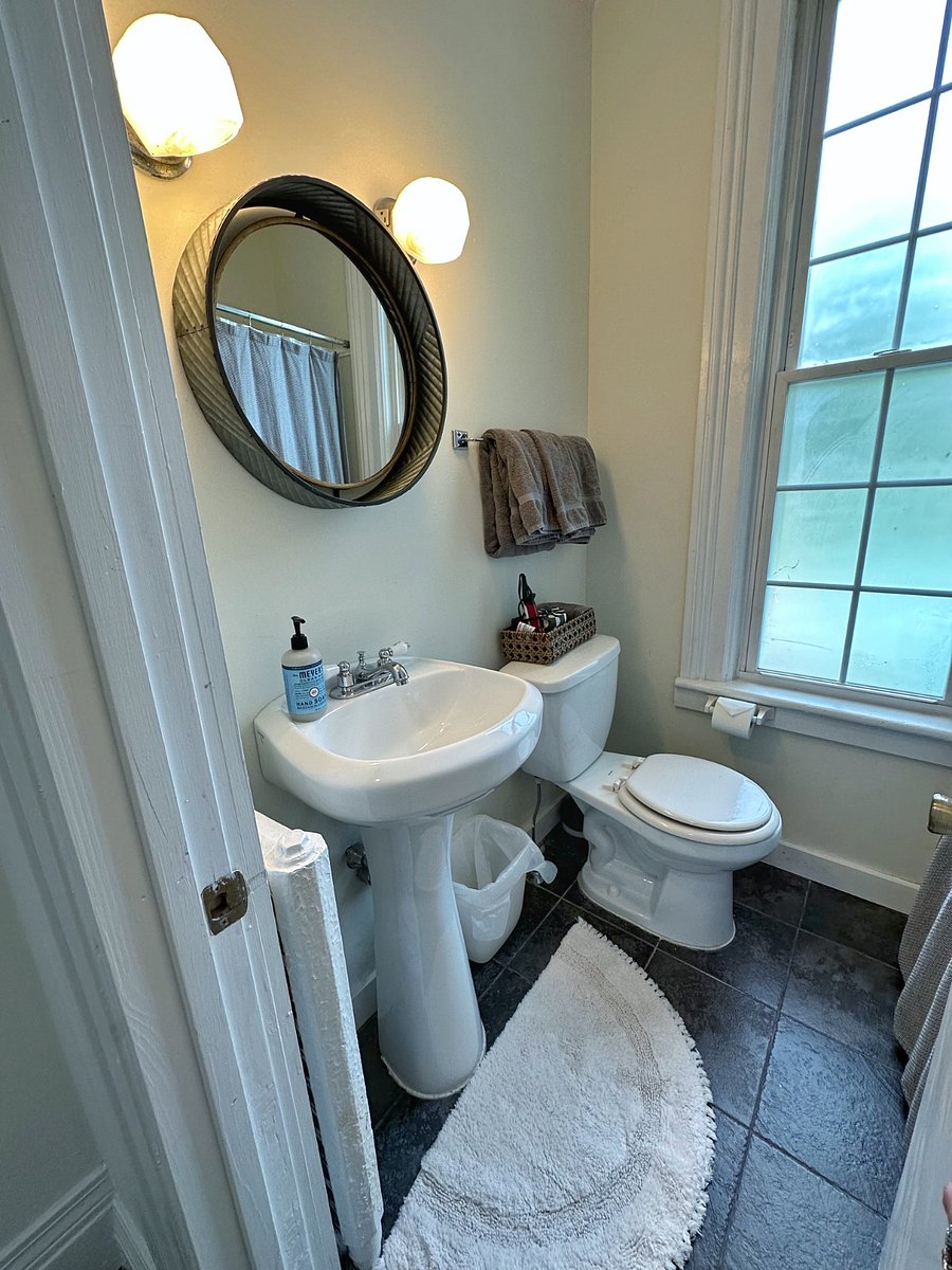 Small but full bath with tub and shower.