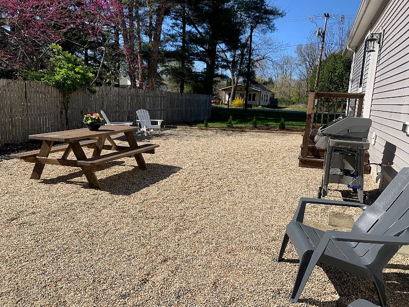 Private side patio, including picnic table and gas grill.
