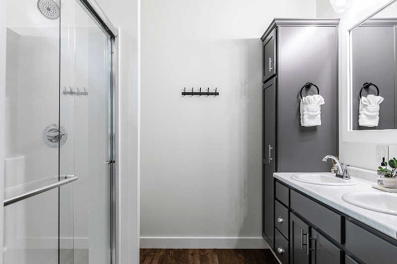 En suite master bathroom featuring dual vanities and walk-in shower.