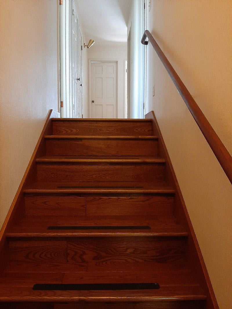 Steps to top floor. First door on left is sunny second bedroom. Door on right is optional third bedroom. 