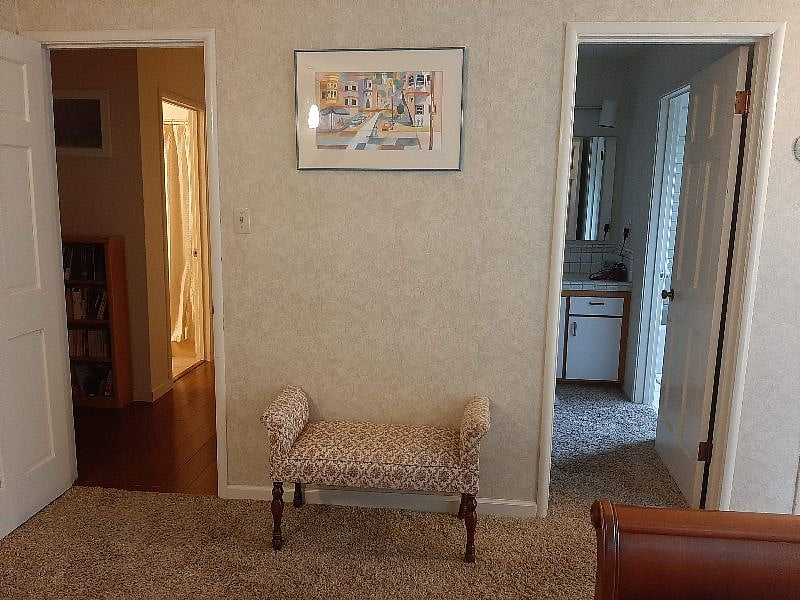 Door on right is master dressing room. Door on left is hallway with closets, another full bath, bedrooms 