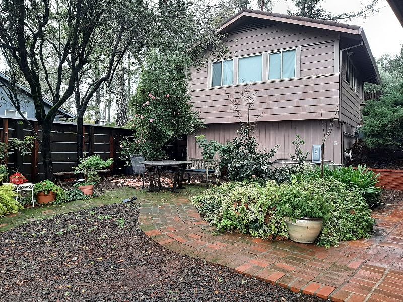 Side yard/garden. Garage/shed building