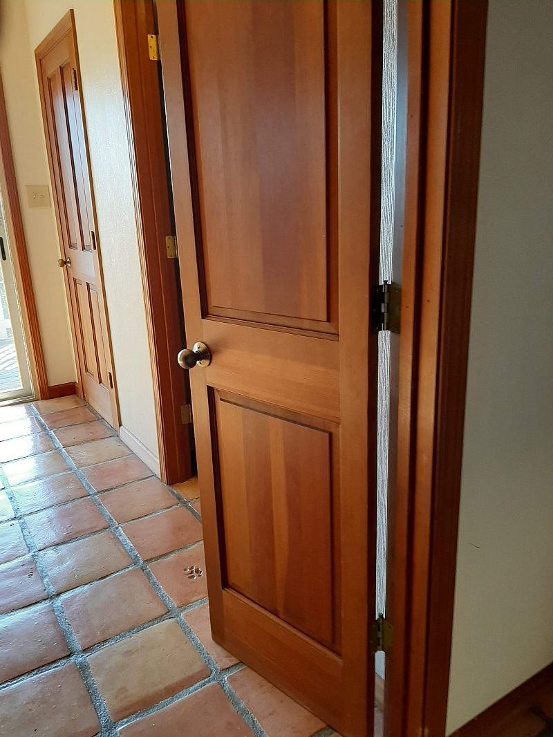 Double doors entrance to bottom floor office, 1/2 bath, and laundry room.