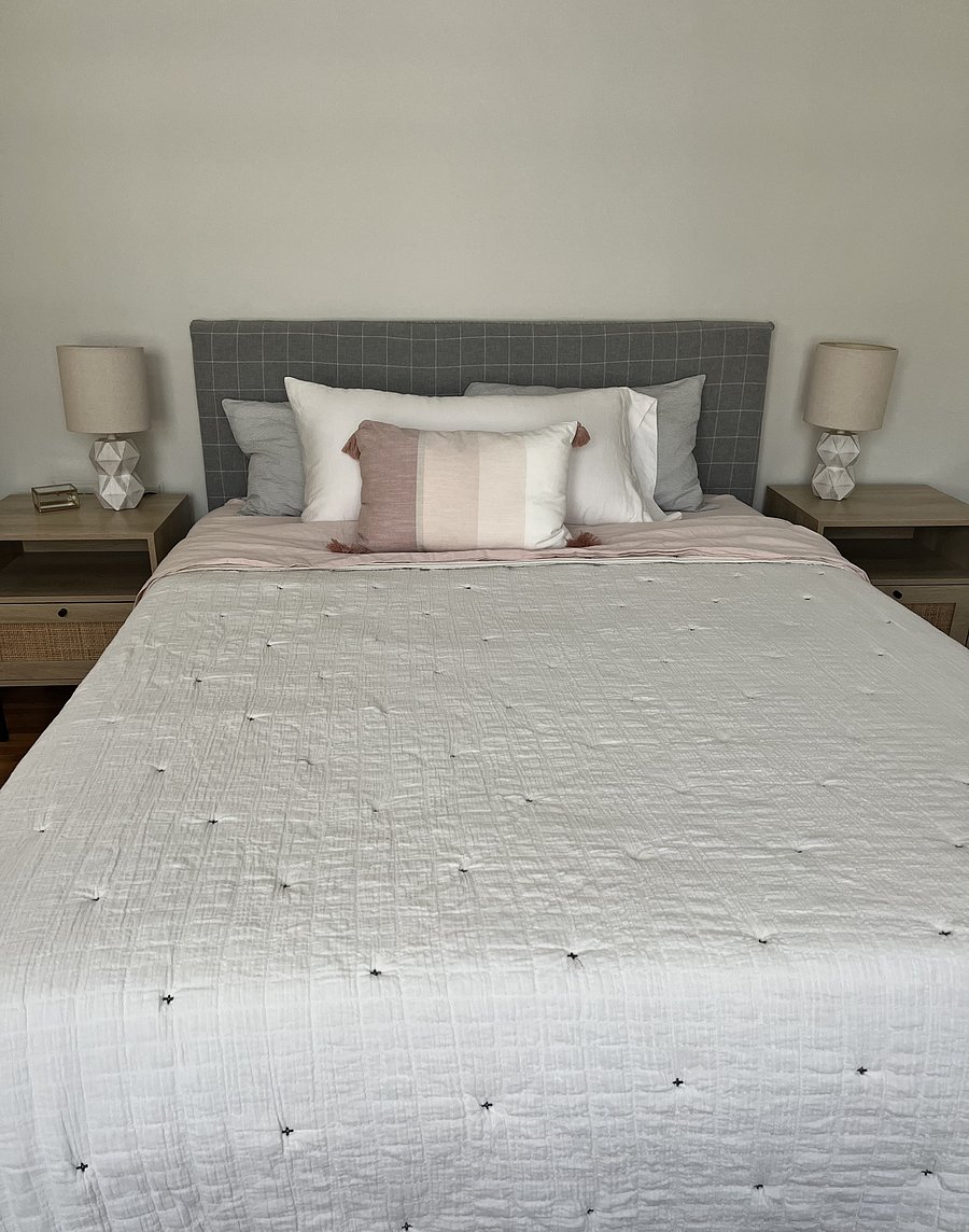 Bedroom 1 features a comfy queen size bed with ample closet and drawer space and a small vanity.