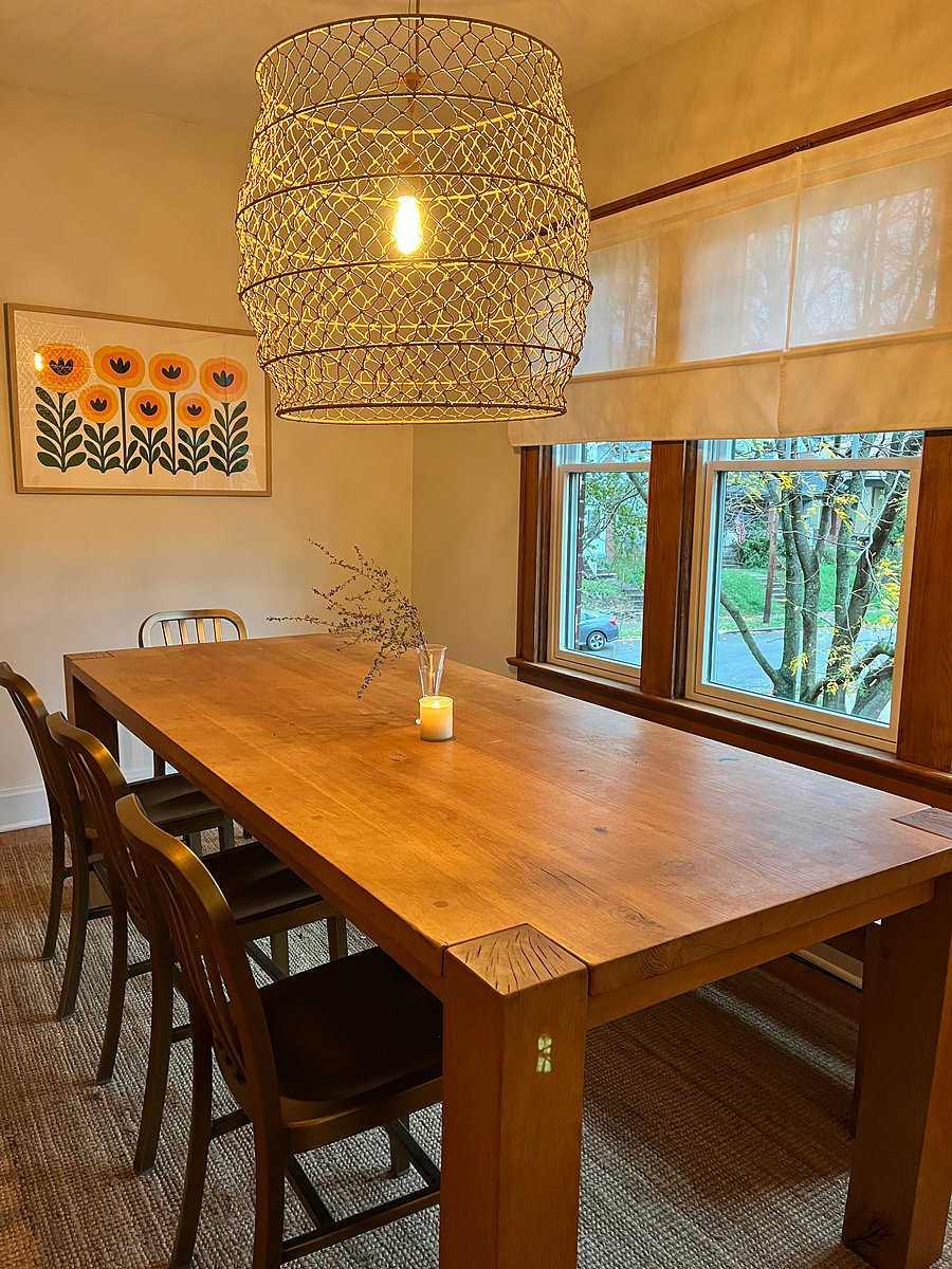 Large dining room table with leafy views. New windows throughout the house.