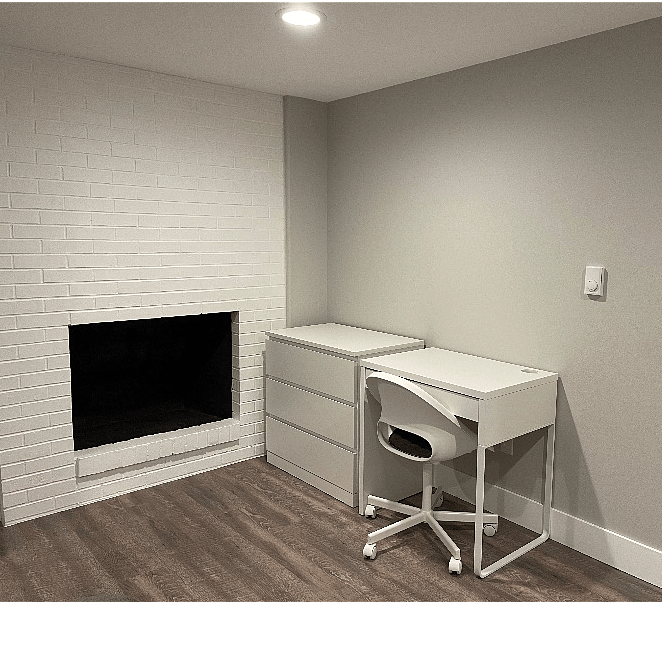 Bedroom 1- dresser, desk with chair, beautiful, non-working fireplace (aesthetic only).