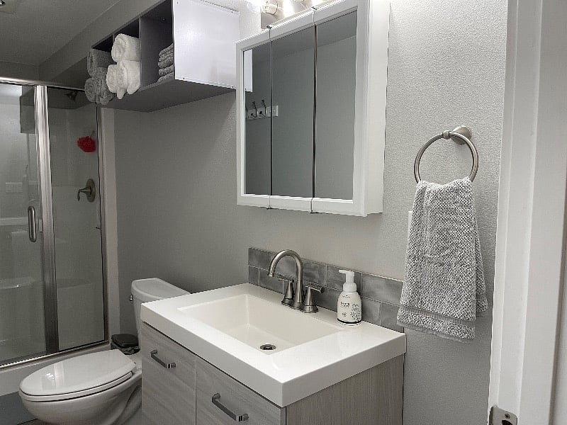 Bathroom with towels & first aid kit below sink. Plenty of storage, too!