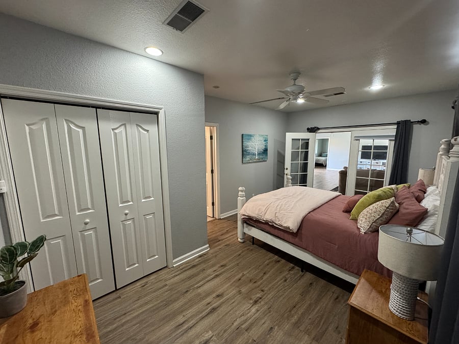 Master bedroom with queen bed, night stands, dresser and closet.