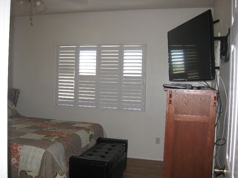 Master bedroom with King size mattress, TV,  balcony, and walk-in closet.
