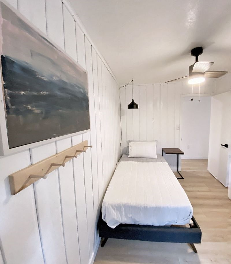Bedroom 2 is smaller and has a twin bed, chair, small dresser and closet