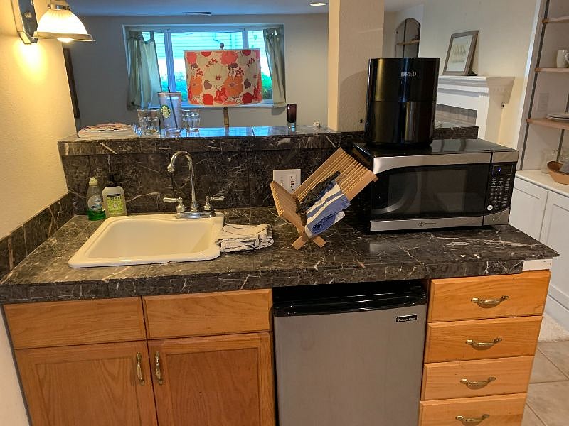 Kitchenette includes all utensils hot plate, microwave, toaster oven, air fryer, 3/4 fridge with freezer. Also has french press for coffee and electric kettle, all utensils.