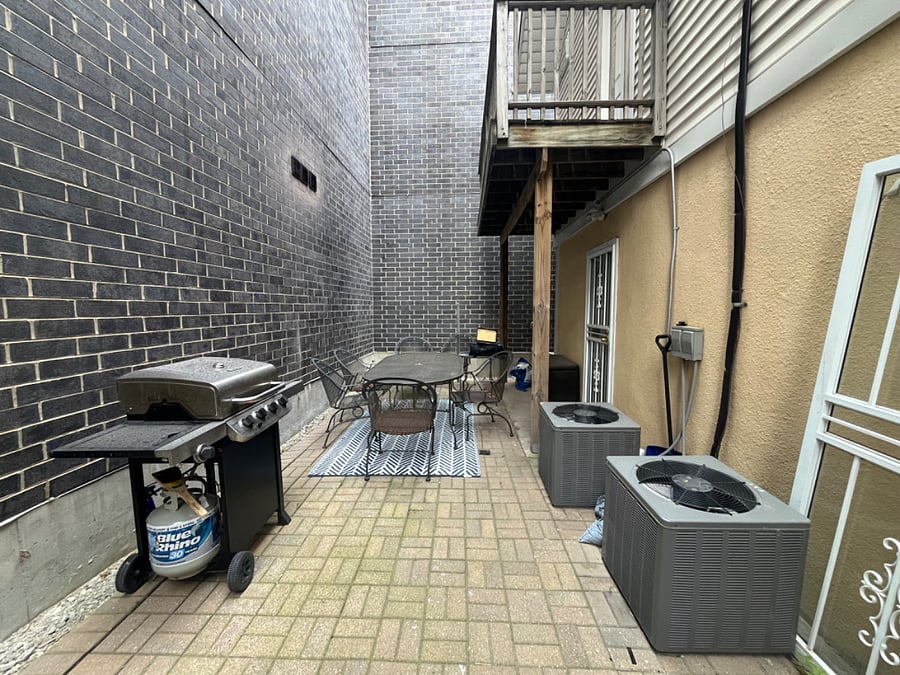 Outdoor patio seating and grill (shared between both units).