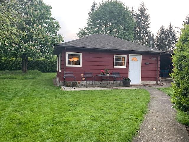 Front of Bungalow with view of side and back yard and chestnut tree.