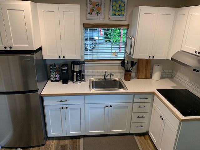 Kitchen area with electric stove top - also includes full set of pots and pans, all utensils and gadgets. Do you like to cook?