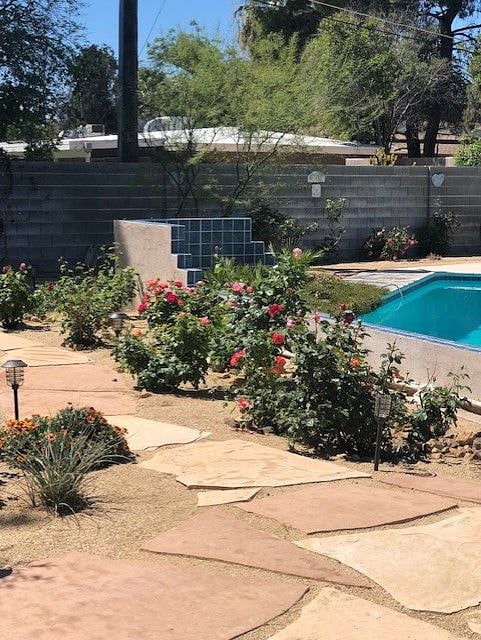 Large rose garden with walking path.
