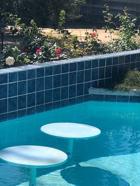 5 built in cocktail tables in pool