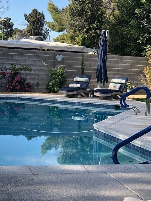 Lounge chairs with table and extra large umbrella for shade