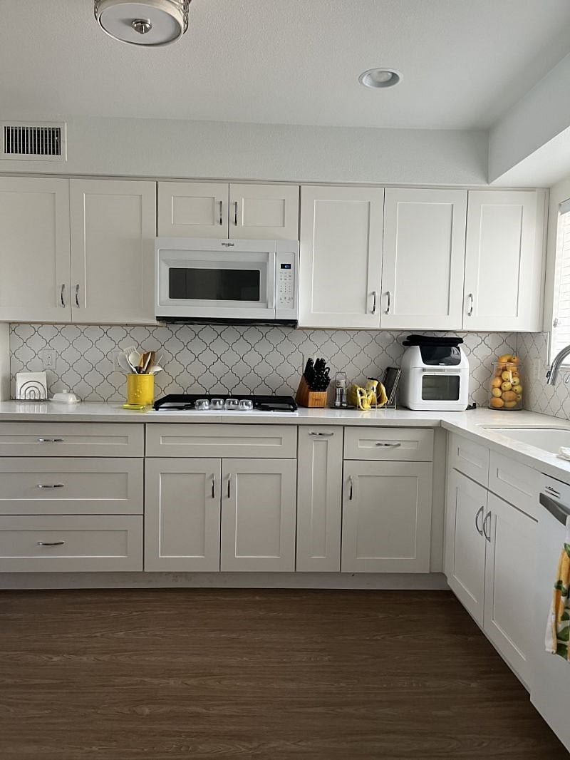 Microwave, gas stove, and air fryer. 