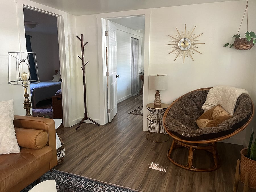 Leather couch and papasan chair in living room.