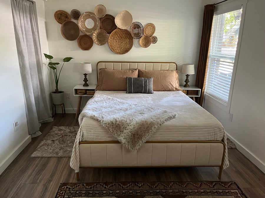 Queen-size bed with foam mattress and topper. Walk-in closet to left of bed.